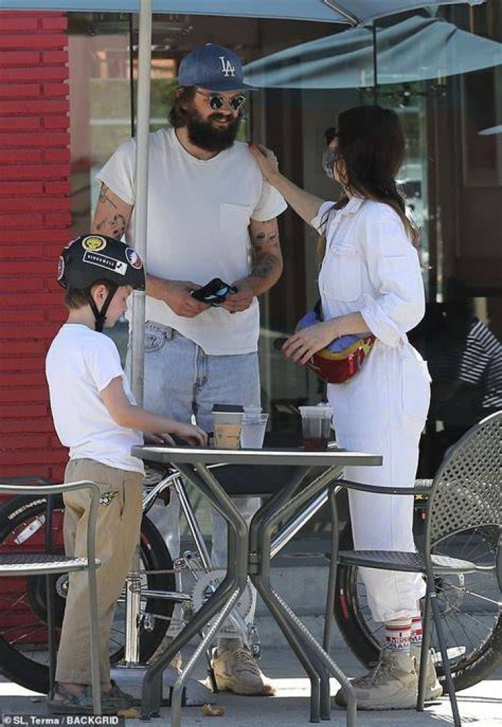 Seen with his son: Thune sported a shaggy beard and long hair, along with rounded sunglasses and a vintage LA Dodgers baseball cap